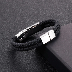 Macro shot of double-layered black braided leather bracelet with magnetic steel clasp