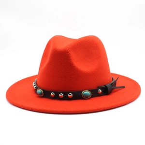 Detail of red wool fedora with black leather band featuring turquoise and silver studs