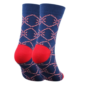 Close-up of knit Christmas crew socks featuring red candy cane patterns on deep blue base