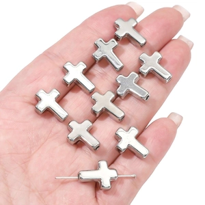 Detailed view of silver CCB cross beads showing smooth surface and bottom hole for DIY