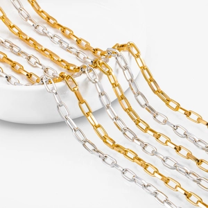 Close-up of gold and silver square link aluminum chains on a ceramic bowl edge