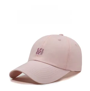 Detail of pink breathable baseball cap with purple embroidered lettering on the front