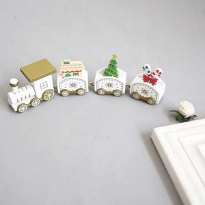 Wooden Christmas train decoration in white and gold featuring small trees and candy canes