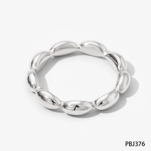 Detailed view of silver stainless steel ring with modern oval beaded design on white background