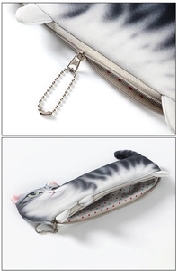 Detail of 3D cat pencil case zipper and metal chain with red polka dot lining