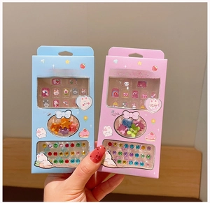 Detail view of cartoon kids nail sticker set with cute star clips and decorative gems