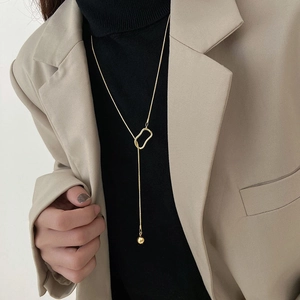 Minimalist gold Y-shaped sweater necklace with geometric hollow rings and ball pendant