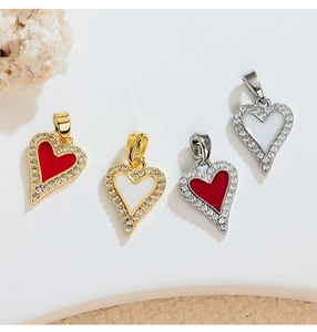 Detailed macro view of heart pendants in gold and silver finish with sparkling rhinestones