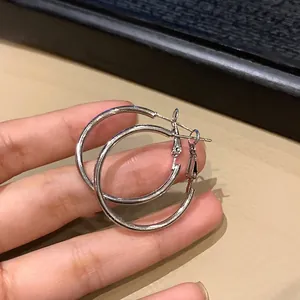 Minimalist silver geometric round hoop earrings with hollow water-drop design for women