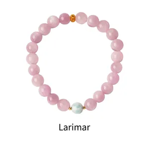 Macro detail of Larimar and purple Glauberite beads with gold accents on the bracelet