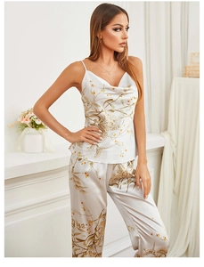 Detailed close-up of a satin pajama set featuring floral prints and stylish cowl neck design