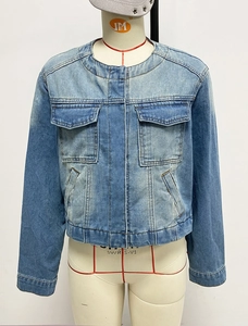 Detail of slim fit light blue denim jacket featuring vintage flap pockets and button closure