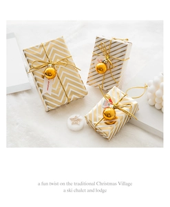 Detailed view of three metallic gold and pearl white Christmas gift boxes on faux fur