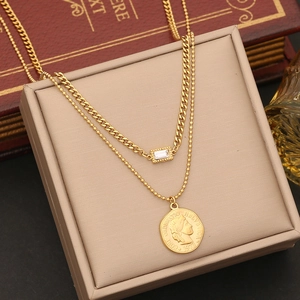 Double-layered gold necklace with a vintage coin pendant and rectangular crystal accent