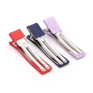 Detailed macro shot of red, blue, and purple grosgrain ribbon wrapped metal duckbill hair clips