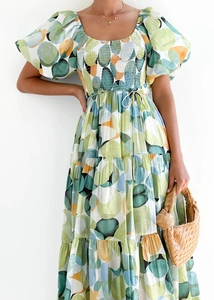 Detail of puffed sleeves and layered ruffles on a floral off-shoulder summer midi dress