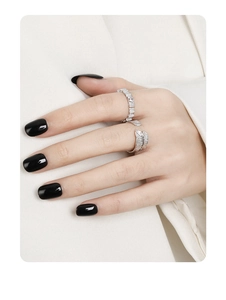 Detail of silver couple rings featuring feather design and crinkle texture on hand
