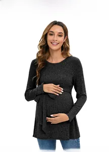 Detail of dark grey ribbed maternity sweater featuring soft knit and waist tie belt