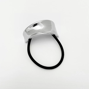 Macro shot of silver curved zinc alloy ornament on a black elastic punk hair tie
