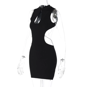 Detail of a sexy black mini dress with butterfly metal decor and side cut-outs