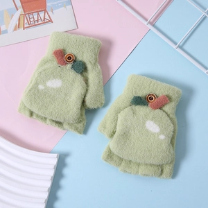 Detail of light green knitted flip-top gloves with brown button and leaf design