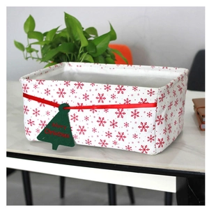 Detailed view of white Oxford cloth storage basket with red snowflakes and Christmas tag