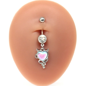Detail view of heart-shaped devil belly ring with opal and zircon on skin model