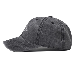 Detailed side view of washed dark grey cotton baseball cap with mountain embroidery
