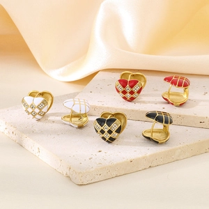 Detail of checkered heart earrings with colorful enamel and sparkling zircon inlay