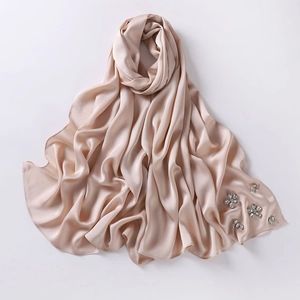 Detailed view of champagne chiffon hijab with sparkling rhinestone floral embellishments