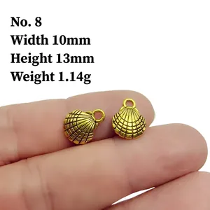 Macro detail of two small gold shell pendants showing size dimensions 10mm by 13mm