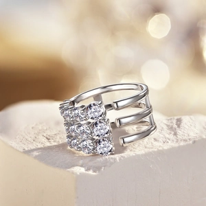 Macro shot of silver multi-layer snake ring with pave-set zircons on white rock