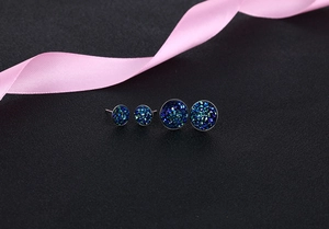 Macro view of blue crystal cluster stud earrings in two sizes with silver plating