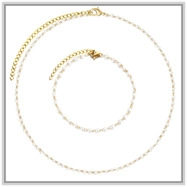 Detailed top view of gold flower chain necklaces with small white pearl accents