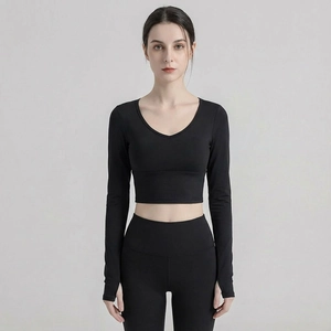 Slim fit black yoga set featuring long sleeve top with thumbholes and high waist leggings