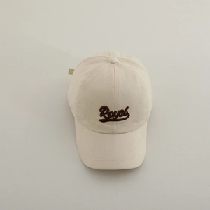 Detailed embroidery of Royal script lettering on beige cotton twill baseball cap