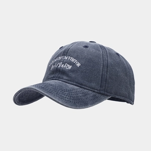 Detailed close-up of embroidered art design on washed grey vintage baseball cap