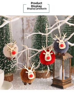 Detailed close-up of colorful reindeer pom-pom ornaments hanging on festive white branches