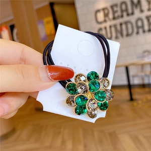 Elastic hair tie with crystal floral design featuring green and clear rhinestones