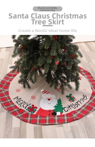 Detail of linen Christmas tree skirt featuring Santa Claus motif and red plaid border
