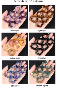 Macro display of six natural crystal flower charms including amethyst and tiger eye