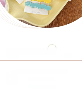 Detail showing dimensions of wave-shaped acetate hair clips in yellow and blue