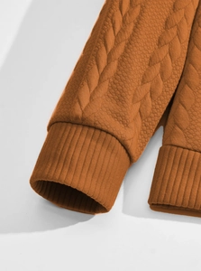 Close-up of caramel jacquard polo shirt featuring elastic ribbed cuffs and diamond texture