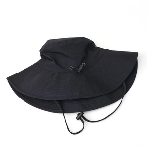Detail of wide brim sun hat with metallic eyelets and adjustable chin strap