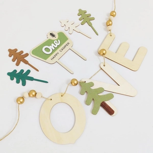 Wooden Happy Camper cake topper and LOVE garland set for forest-themed birthday party decor