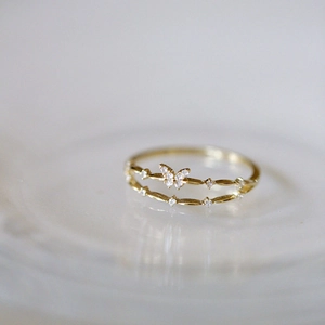 Macro shot of double-layered butterfly ring with sparkling zircon stones and gold plating