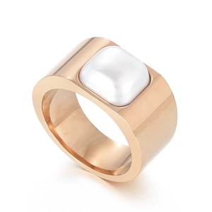 Rose gold geometric wide ring with white shell inlay shown from a 45-degree angle