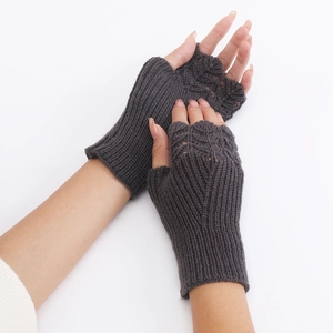 Detail of dark grey knitted fingerless gloves showing premium fish scale texture and wrist cuffs