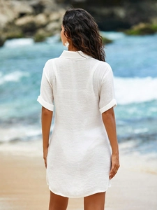 Rear view of a white short-sleeve beach cover-up shirt with semi-sheer fabric