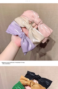 Close-up of elegant satin bow headbands in various candy colors with a silky finish